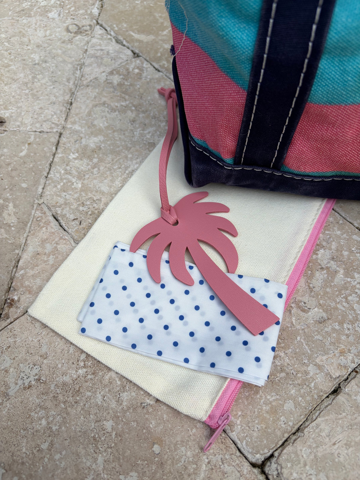Flat lay presentation of the included 3-piece styling kit accessories next to the vintage blue and pink rugby stripe L.L. Bean tote bag.