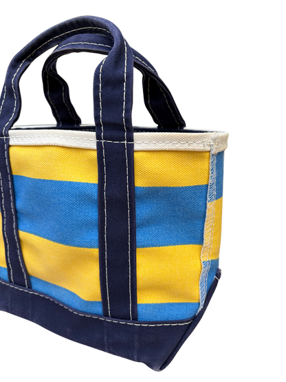 Angled top down three quarter view of Vintage L.L. Bean Tote — Mini Navy and yellow rugby Stripe canvas bag showing the opening.