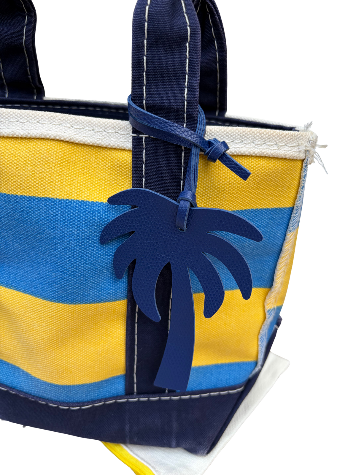Side profile view of Vintage L.L. Bean Tote — Mini Navy and yellow rugby Stripe showing the zip top closure and gusset seams.