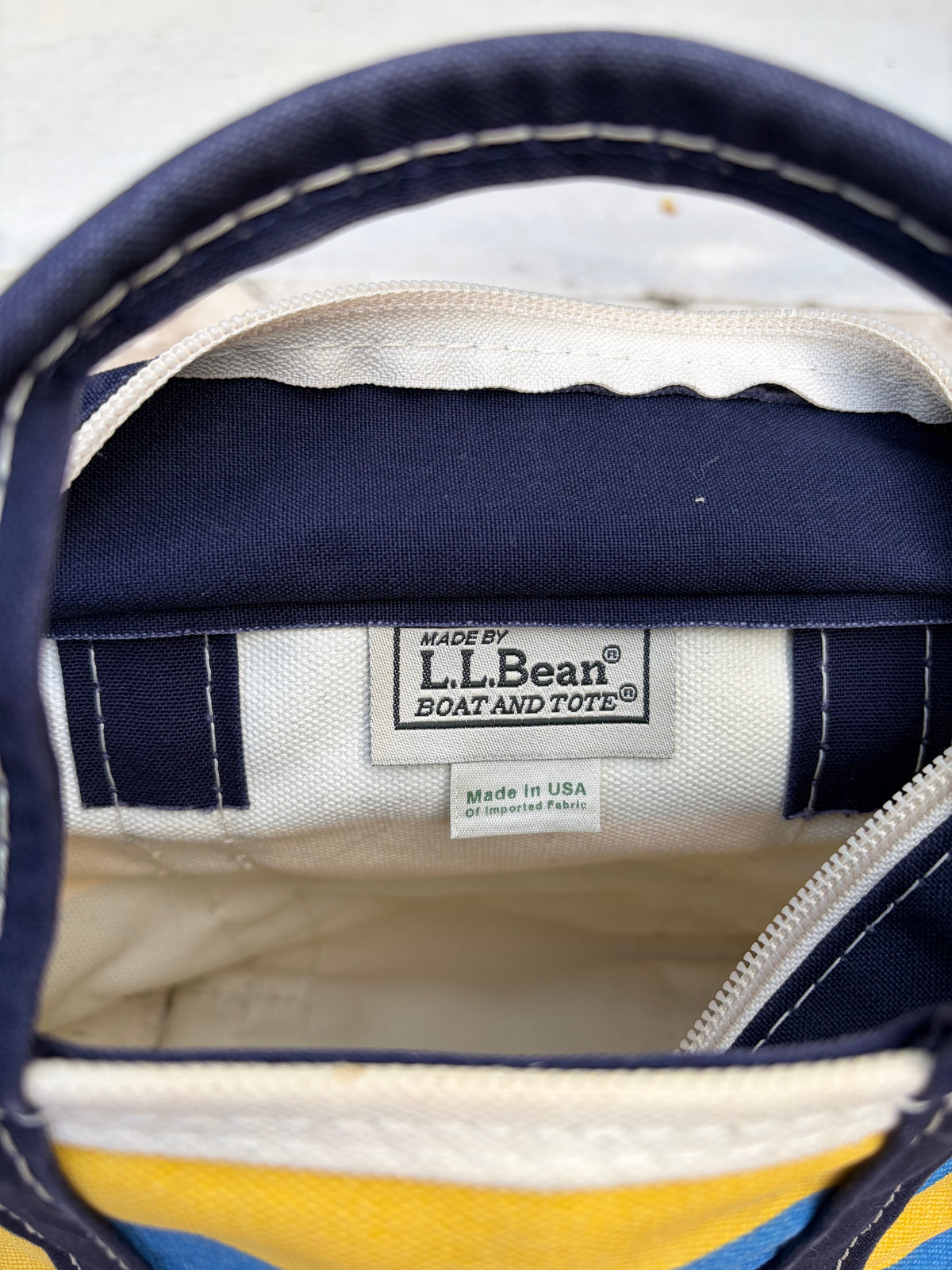 Close-up of the crisp interior L.L. Bean manufacturer label reading Made in Freeport, Maine, USA on a Vintage L.L. Bean Tote — Mini Navy and yellow rugby Stripe.