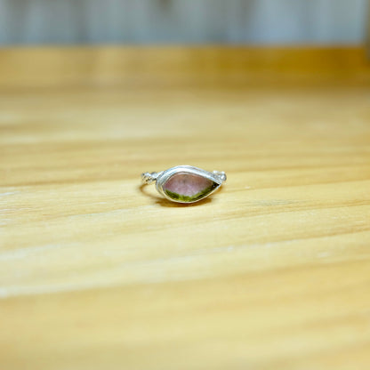 A stunning watermelon tourmaline ring featuring a vibrant pink and green gemstone set in a delicate sterling silver band.
