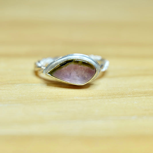 A beautiful watermelon tourmaline ring, size 6, with a striking pink and green gem, elegantly designed in a polished sterling silver band.