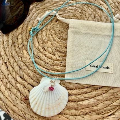 White fan shell mother of pearl pendant with pink topaz close-up