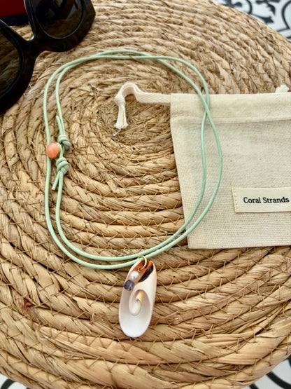 White spiral shell pendant with pearl, and iolite close-up