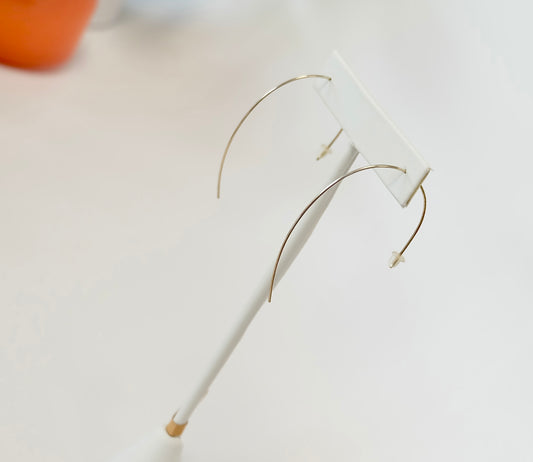 Minimalist wire threader earrings worn in a double piercing