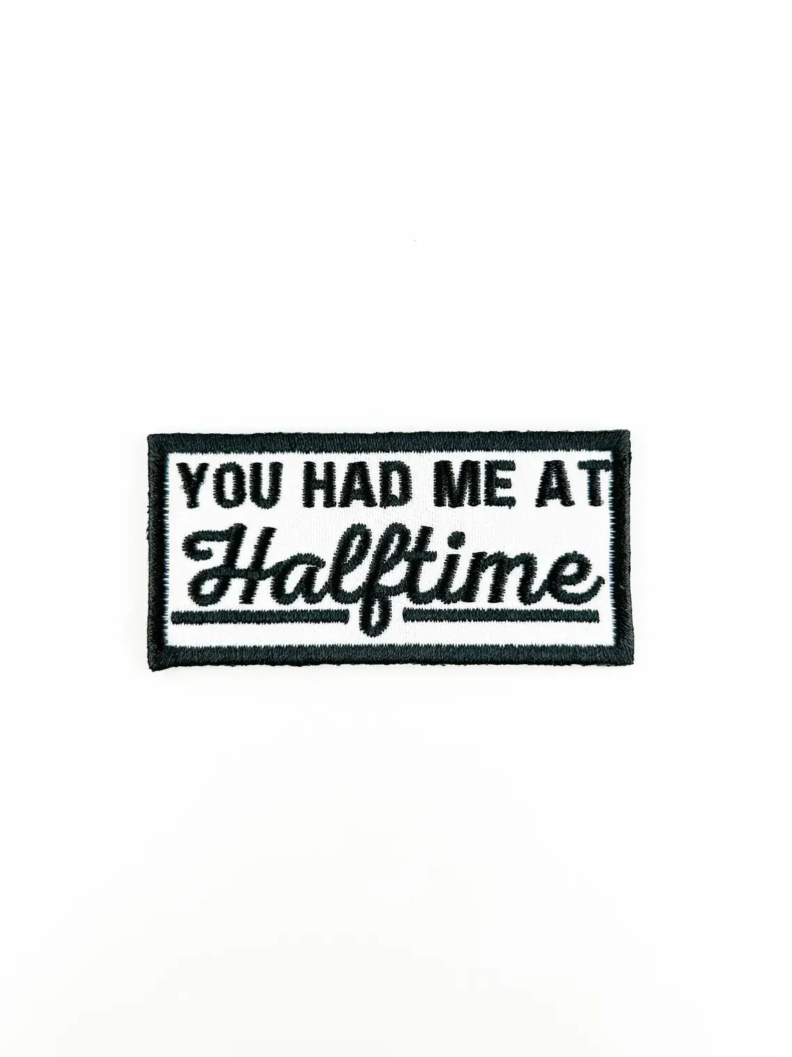 A rectangular embroidered patch with a black border and white background, featuring the text 'YOU HAD ME AT Halftime' in black lettering.