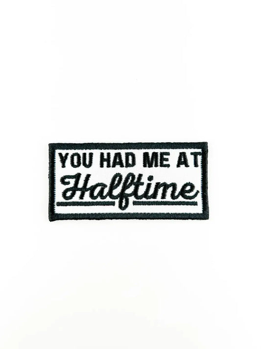 A rectangular embroidered patch with a black border and white background, featuring the text 'YOU HAD ME AT Halftime' in black lettering.